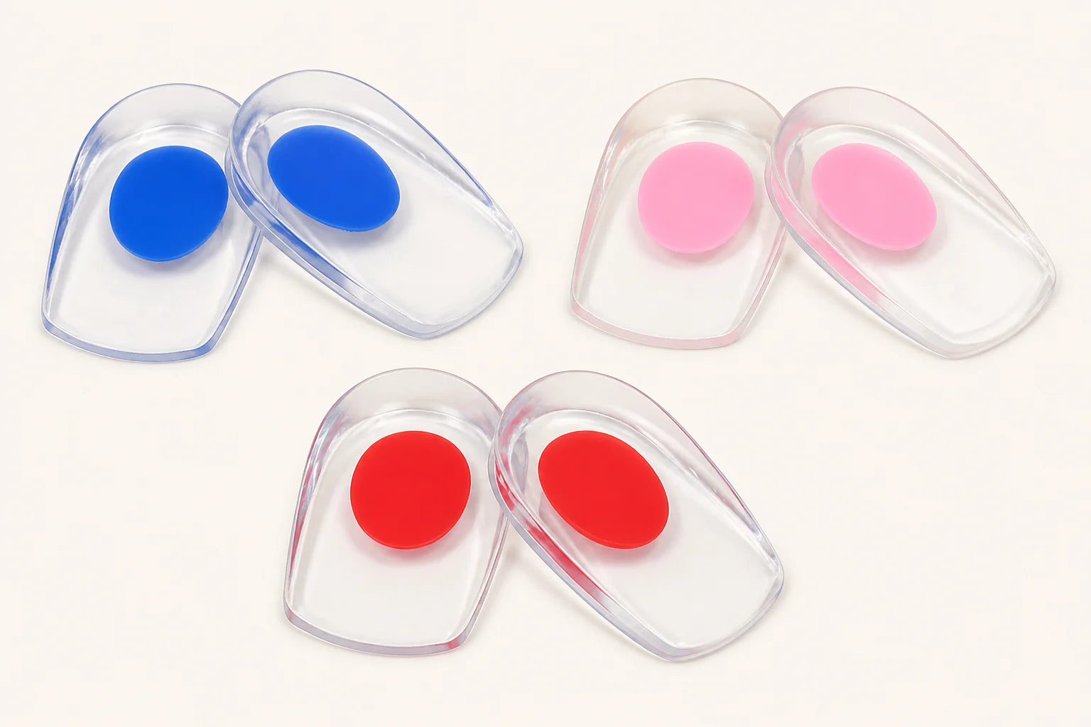 Three pairs of HeelSaver cushions with blue, pink, and red center zones